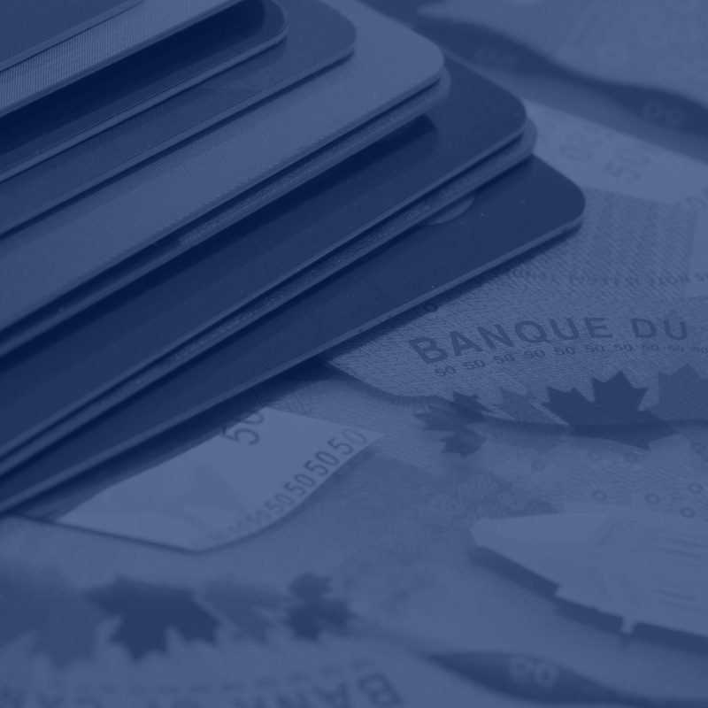 close up of stacked credit cards on top of money